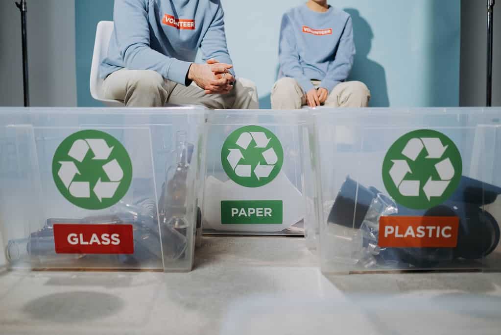 2 person recycling glass paper and plastic