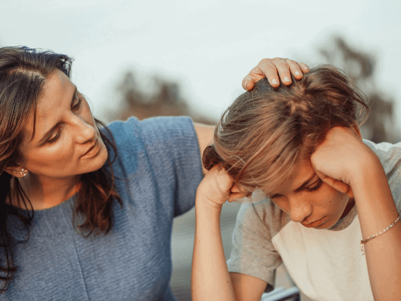 A mother talking to her sad son.